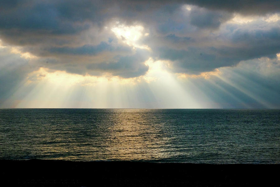 2-beams-of-sunlight-rays-shining-through-dramatic-clouds-onto-the-gill-copeland