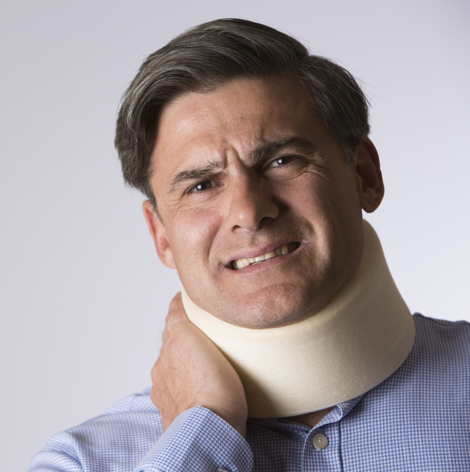 Studio Shot Of Masn In pain Wearing Neck Brace